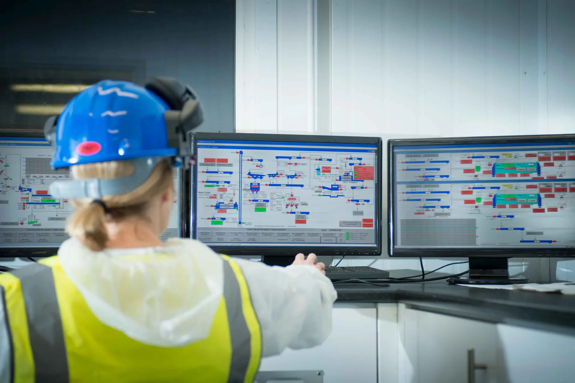 Factory operator monitoring SCADA control room screens, showing untapped Dynamics 365 F&SCM production data going unused across manufacturing operations | Dynamics Monk.
